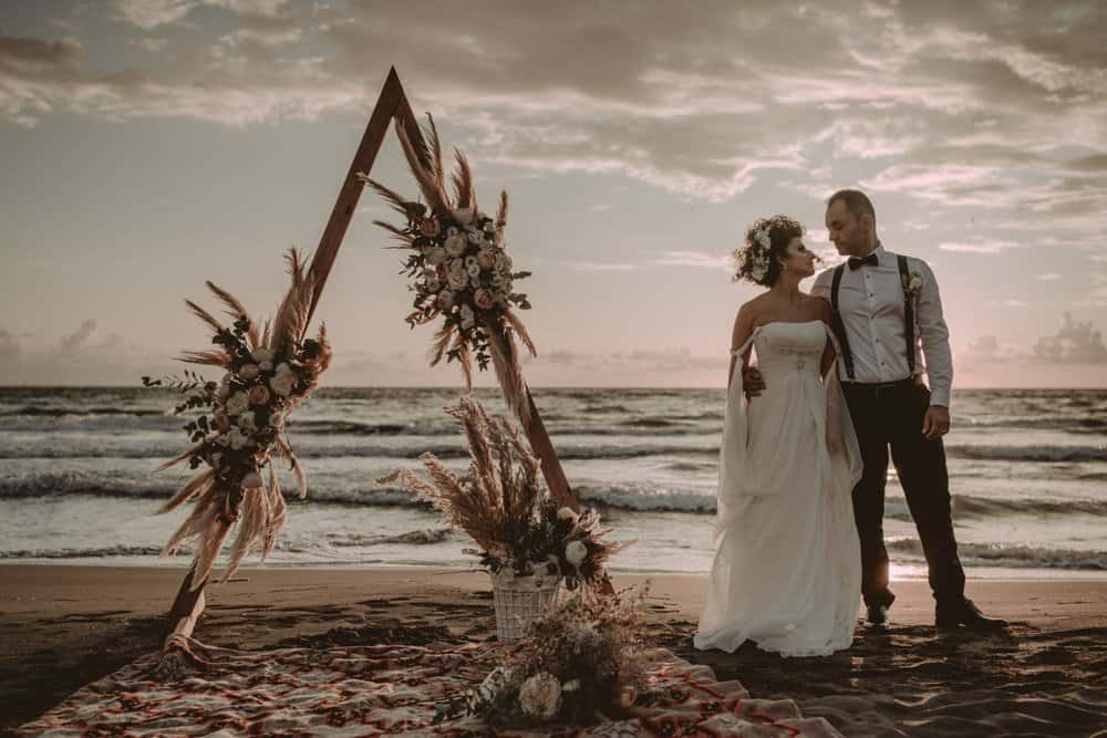 Elegant beach wedding ceremony featuring a romantic sunset backdrop at a luxury seaside venue.