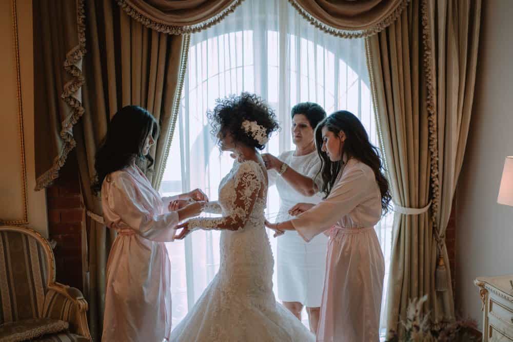Luxury wedding preparation with bride and bridesmaids in elegant bridal suite.