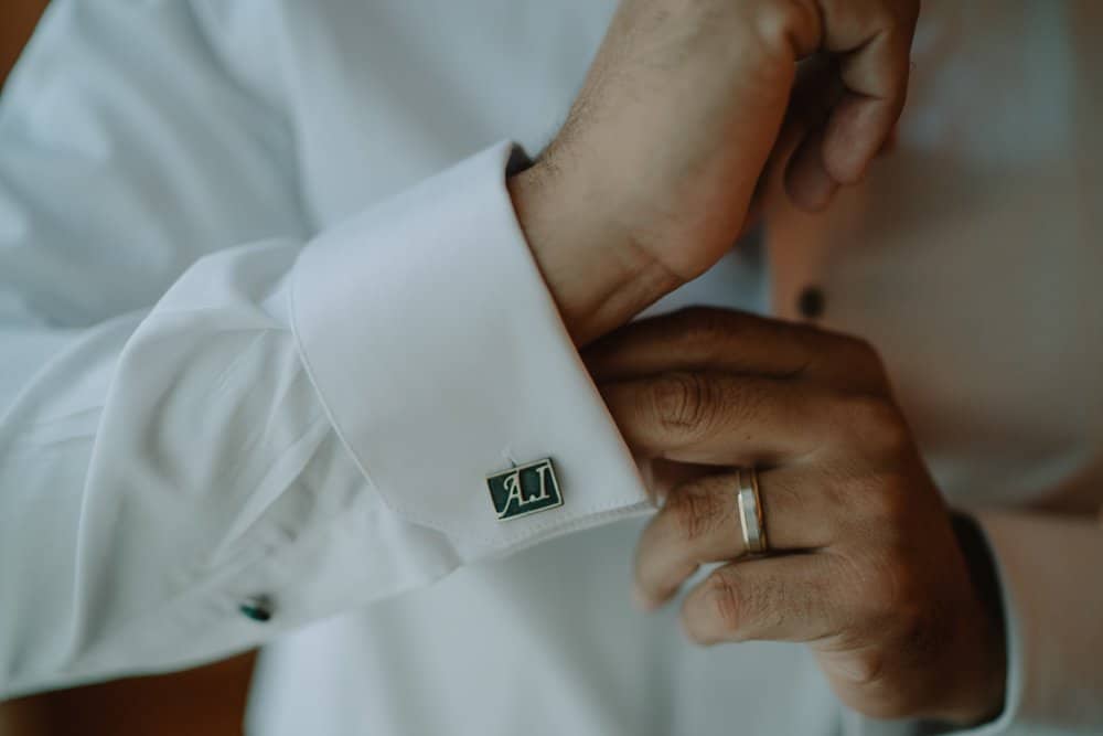 Elegant men's dress shirt cuff with custom cufflink, perfect for luxury wedding attire.