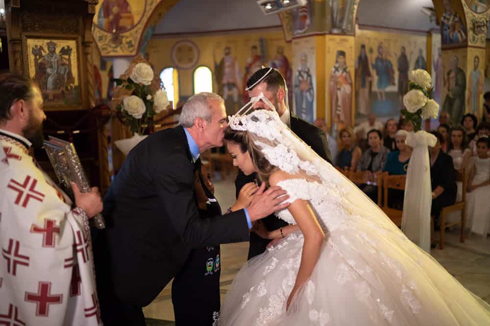 Elegant wedding ceremony with a bride and groom in a beautifully decorated church.