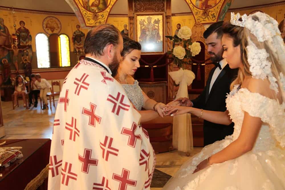 Vintage wedding ceremony at a high-end church with ornate religious icons and elegant decor.