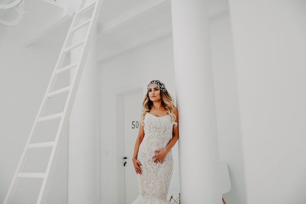 Elegant bride in a luxury wedding dress at a high-end venue with modern, minimalist design.