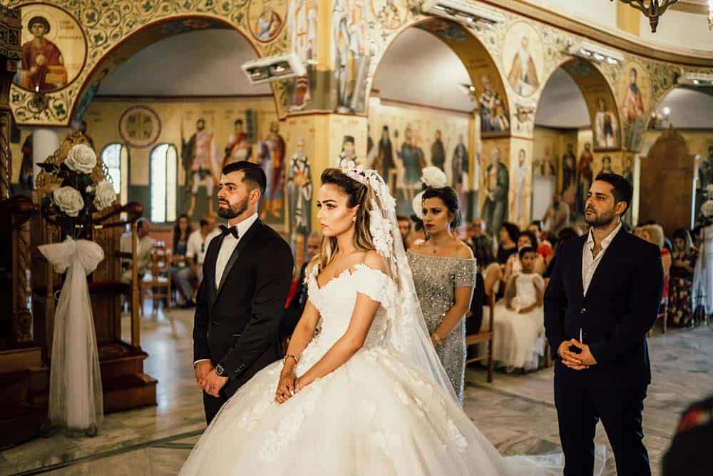 Elegant wedding ceremony inside a breathtaking high-end church with intricate religious artwork and a luxurious atmosphere.