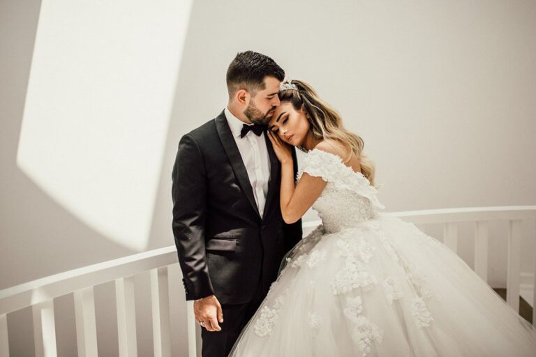 Elegant wedding couple sharing intimate moment in modern venue.