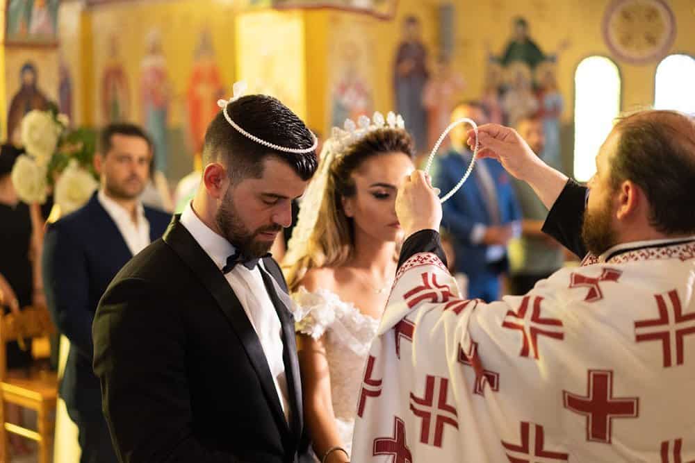 Luxury wedding ceremony at a high-end church with ornate religious icons and elegant decor.