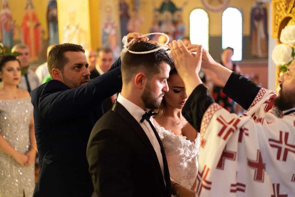 Elegant wedding ceremony in a luxurious church setting with clergy presiding over a couple's vows.