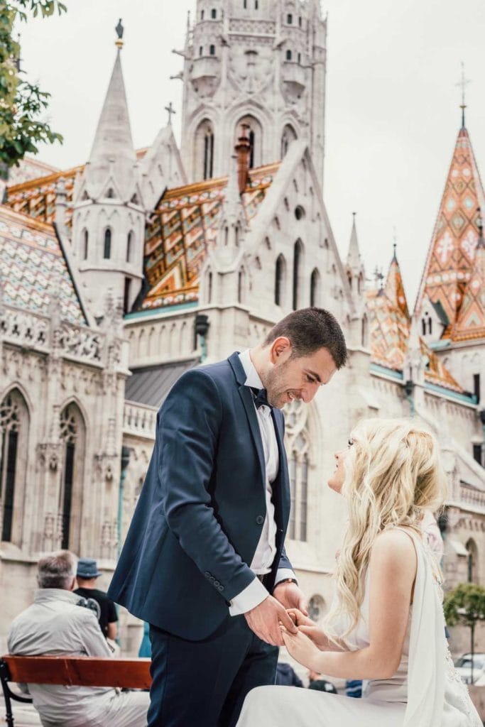 Elegant wedding couple sharing vows in front of a historic castle, showcasing luxury wedding photography.