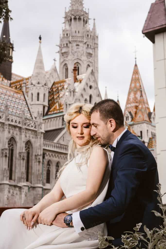 Elegant bride and groom in love at a fairy-tale castle wedding venue, capturing a romantic moment amidst luxurious surroundings.