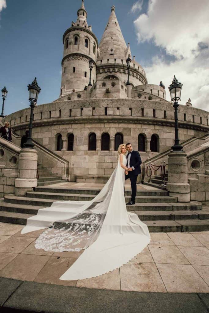 Luxury wedding at fairy tale castle with bride and groom, elegant high-end venue, romantic wedding photography, historic European architecture, glamorous wedding scene, stylish bridal gown and suit, memorable wedding moment, architectural elegance, timeless wedding venue, sophisticated wedding setting, visite studio, luxury event photography, high-end wedding destination, wedding couple in romantic pose, iconic castle backdrop, professional wedding photography, luxury event capturing, elegant wedding attire, aristocratic wedding atmosphere, premium wedding venue, picturesque wedding scene.