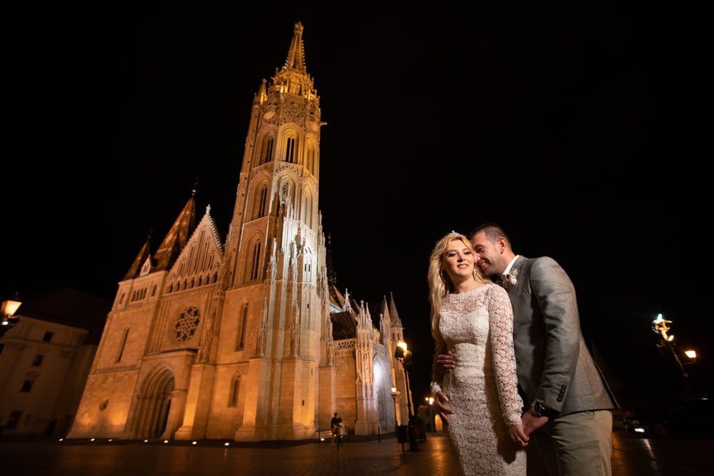 Elegant night wedding photo outside a historic cathedral, showcasing luxury wedding photography services.