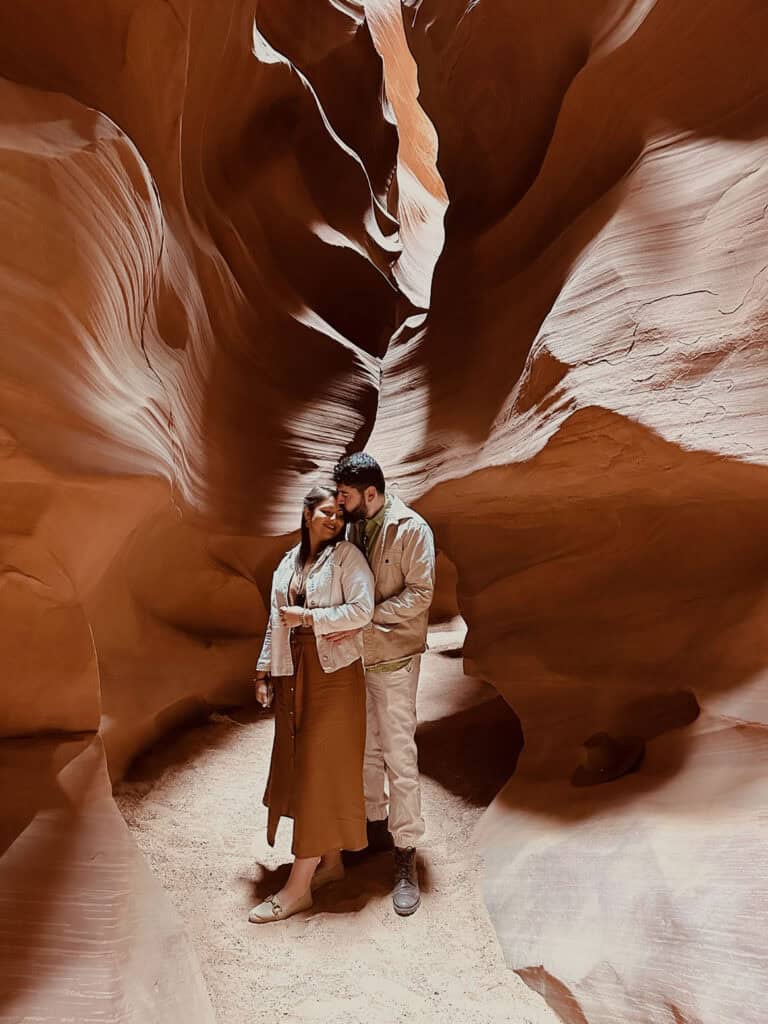 Desert canyon couple photo, romantic moment in the majestic red rock formations, perfect for luxury wedding photography.