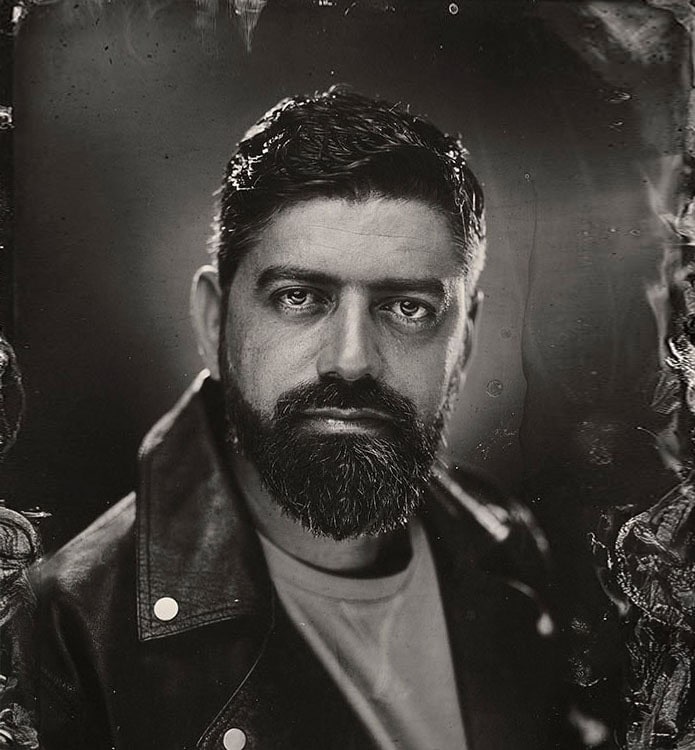 Portrait of a man with a beard in black and white, high-end photography style.