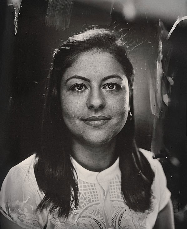 Elegant woman with dark hair and classic makeup, portrait in black and white.
