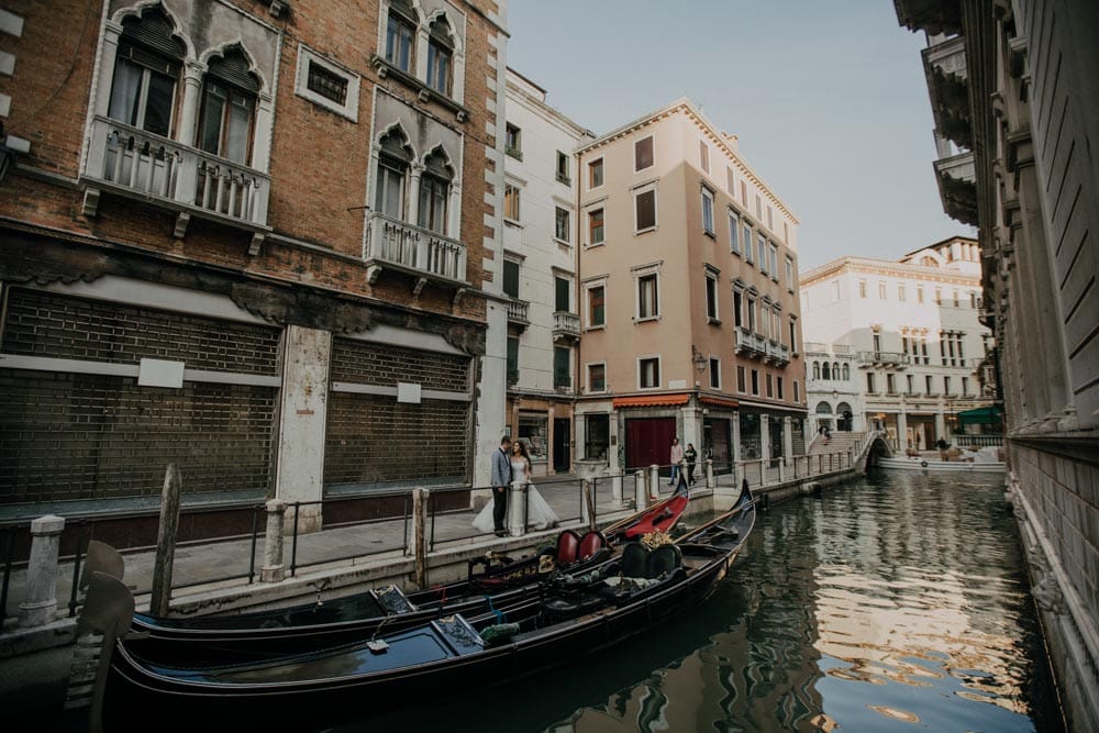 Venetian canal with gondolas and historic high-end buildings, perfect for luxury wedding venues in Venice.