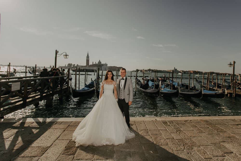Elegant wedding couple at a luxurious Venice waterfront venue, romantic high-end wedding setting.