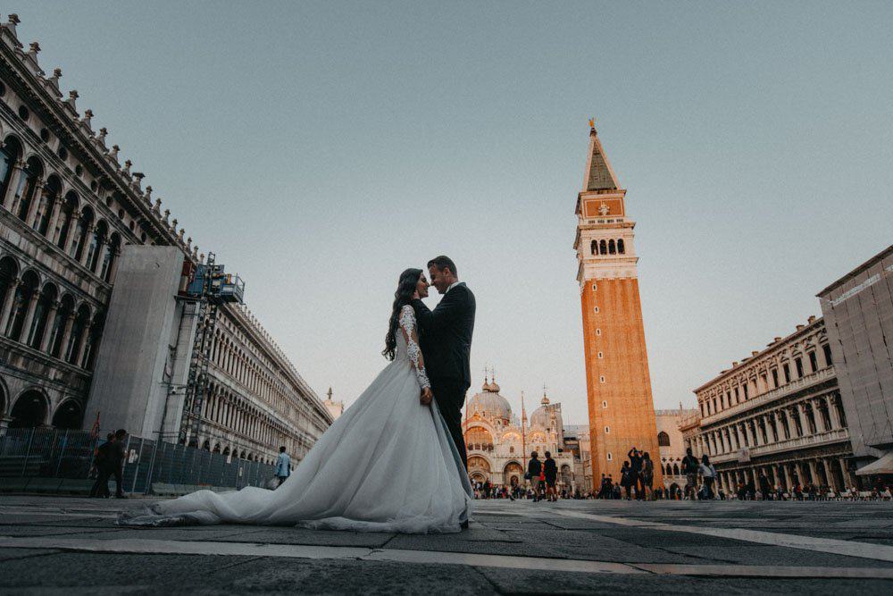Elegant wedding couple in Venice Piazza San Marco, surrounded by historic architecture, capturing a luxurious wedding moment.