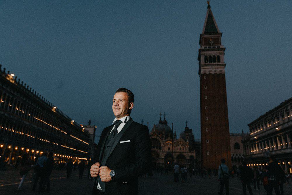 Elegant man in tuxedo at St. Mark's Square, Venice, during evening, ideal for luxury wedding destination photos.