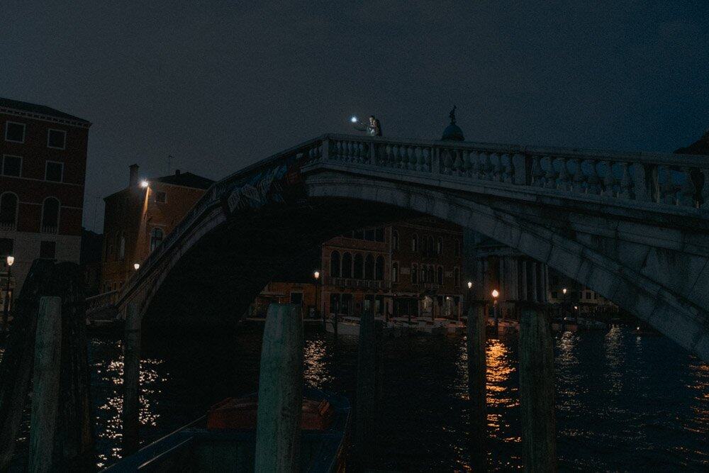 Elegant night view of a romantic Venice bridge over water, ideal for luxury wedding photography and high-end event venues.