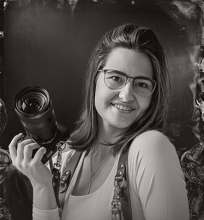 Luxury wedding photographer captured in elegant setting with high-end event venue.