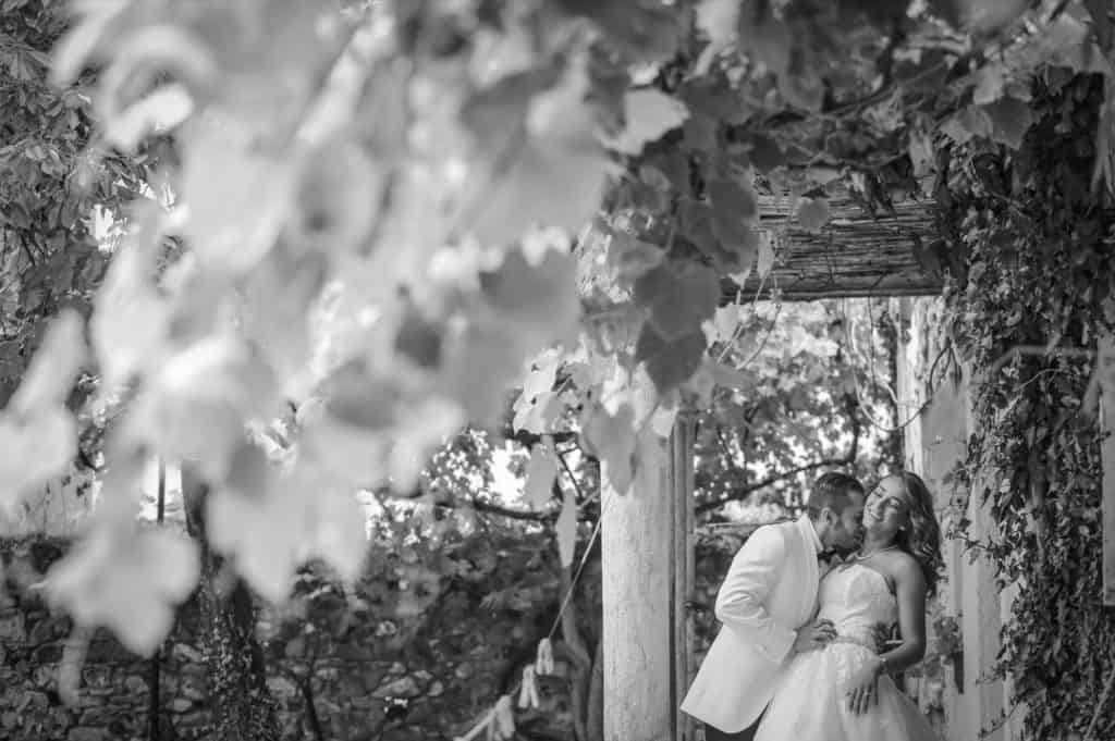 Elegant couple sharing a romantic moment in a lush garden setting for a luxury wedding venue.