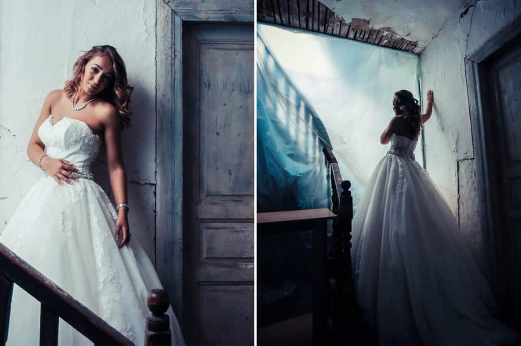 Vintage bridal portrait in elegant wedding gown leans against rustic wall at luxury estate wedding venue.