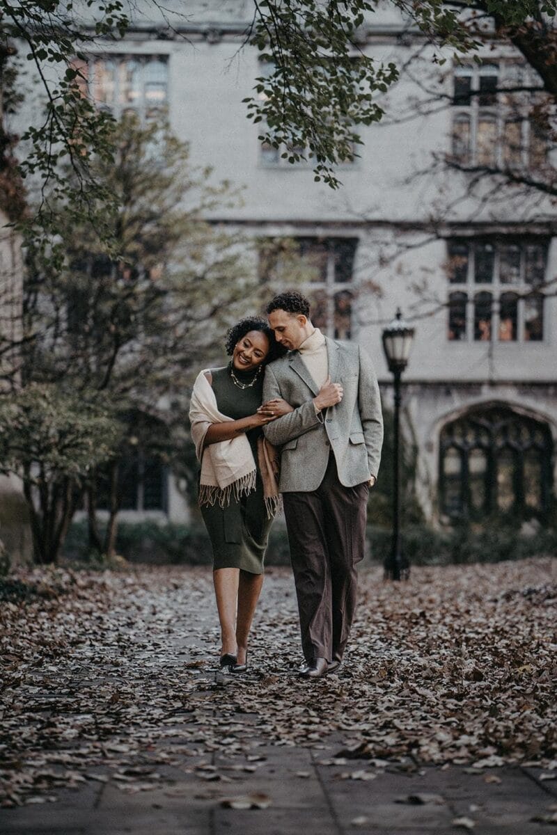 Elegant couple walking outdoors in fall, ideal for luxury destination wedding photography.