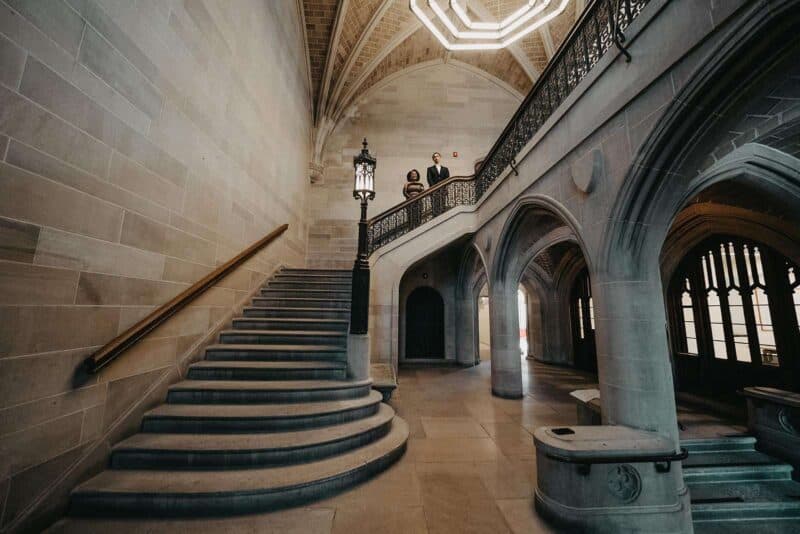 Elegant historic wedding venue with grand staircase and intricate architectural details.