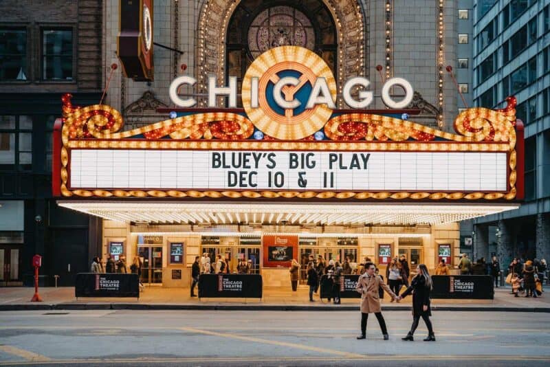 Chicago Theatre marquee illuminated at night, showcasing an upcoming event for a luxury wedding celebration.
