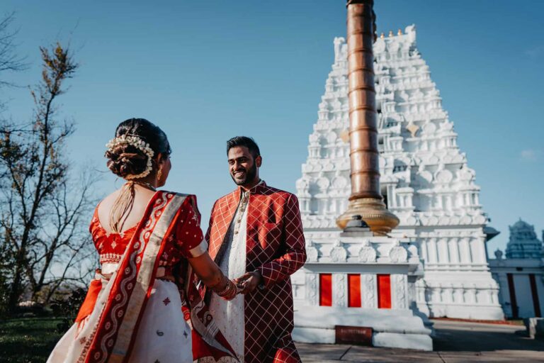 Luxurious Indian wedding ceremony at a traditional temple with vibrant attire and intricate details.