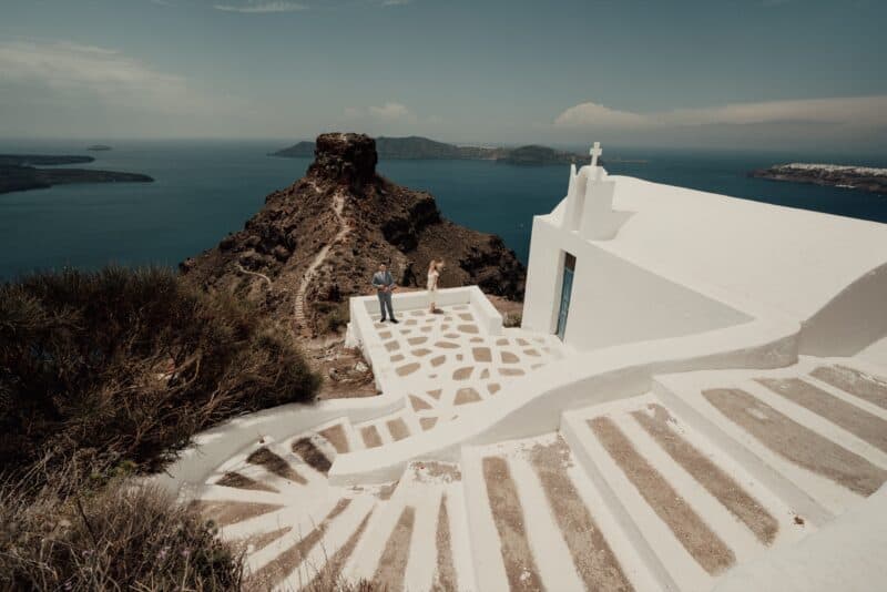 Breathtaking views of a white chapel on a Greek island overlooking the sea, perfect for luxury destination weddings.