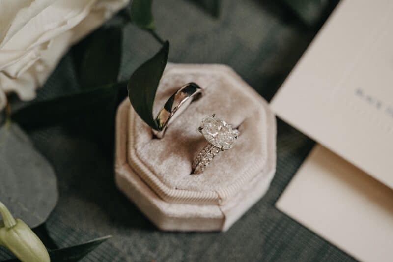 Elegant diamond engagement ring and wedding band in plush velvet box for luxury wedding jewelry.