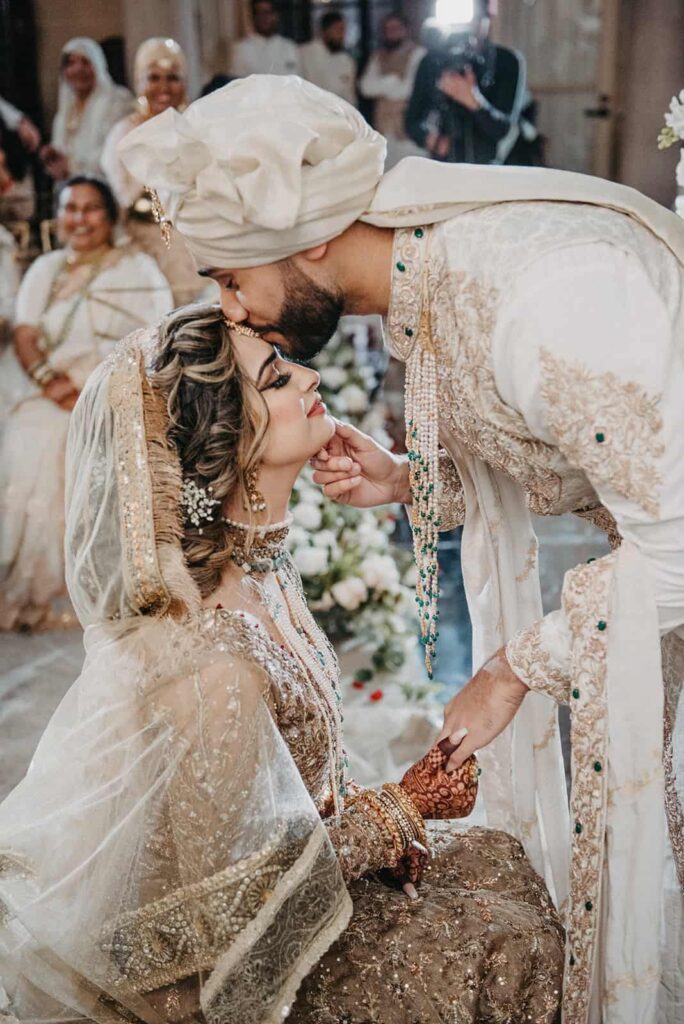 Beautiful Indian wedding ceremony featuring a couple in traditional attire, surrounded by family and friends, highlighting luxury wedding traditions and high-end celebration ambiance.