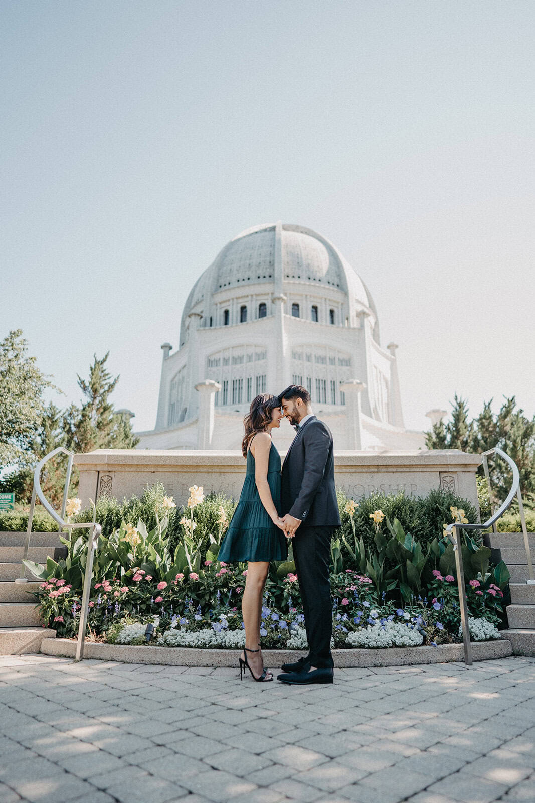 Elegant couple holding hands in front of the Griffith Observatory, perfect for luxury wedding photography and high-end event venues.