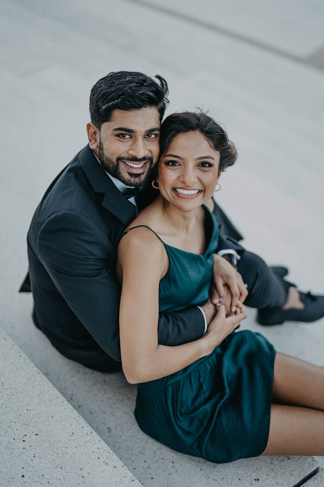 Elegant couple celebrating a luxurious wedding in a high-end venue, capturing their joyful moment with stylish attire.