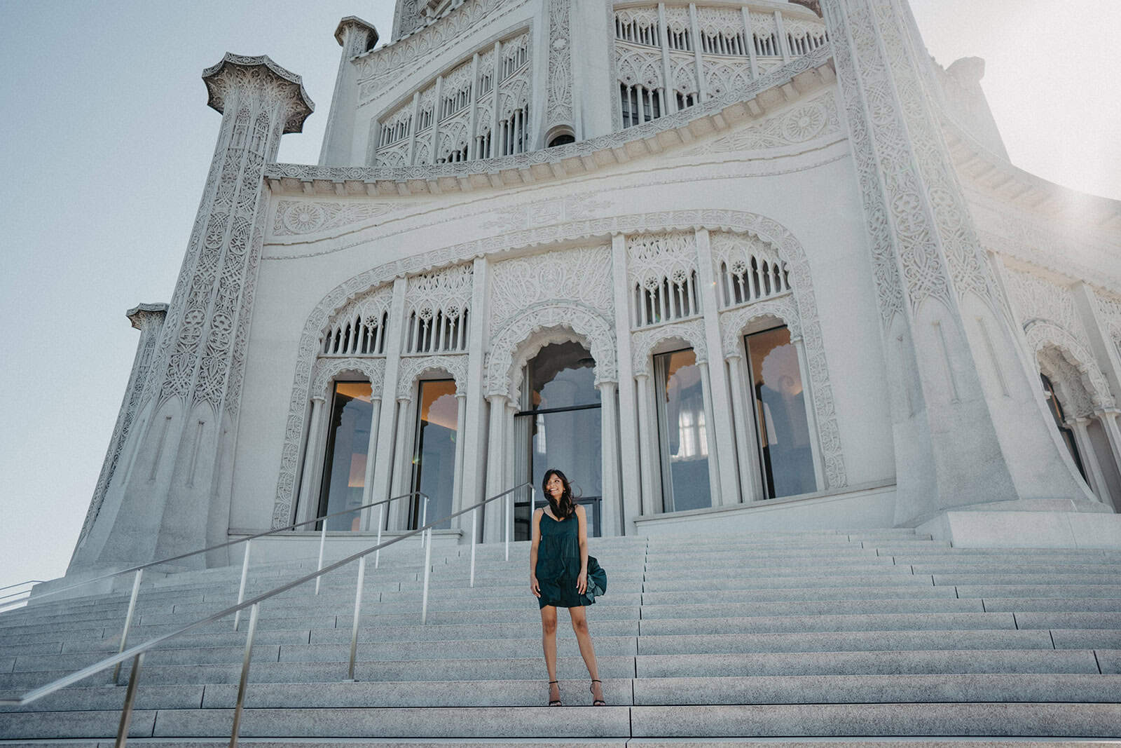 Majestic white castle with intricate architectural details and grand staircase, perfect for luxury wedding venues and elegant events.