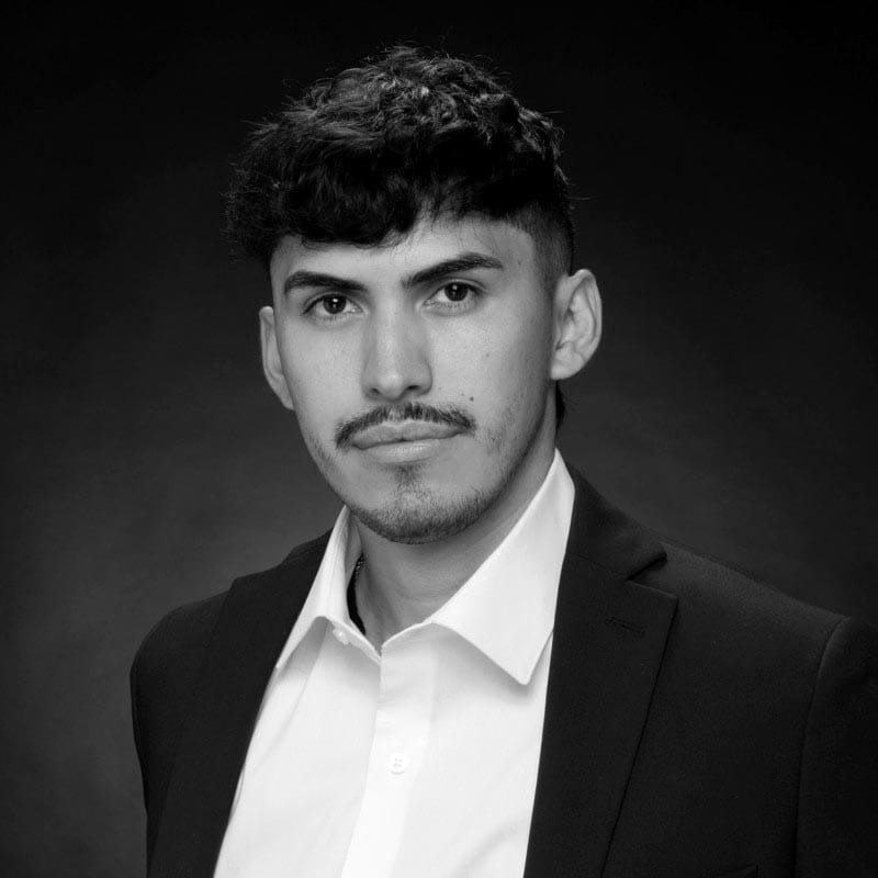 Elegant portrait of a young man in formal attire for luxury wedding photography.